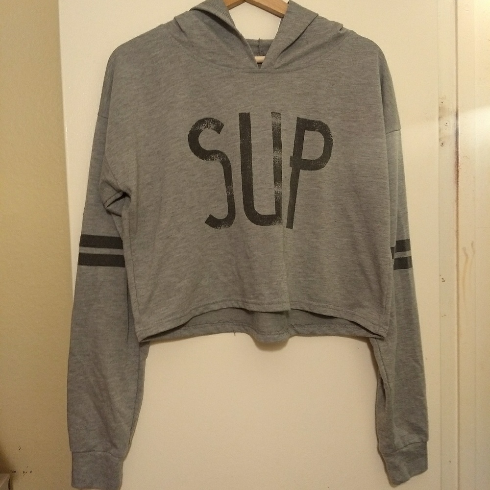 A grey "SUP" crop top hoodie